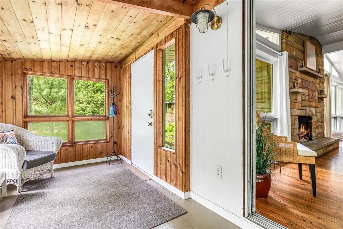 Enclosed Sunroom with Wicker Furniture & Wood Paneling