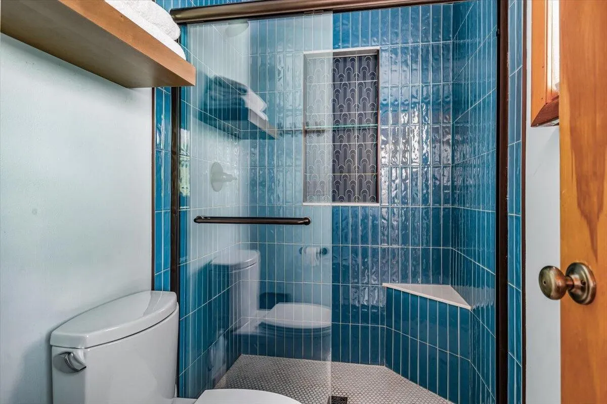 Luxurious Blue Tile Shower with Glass Doors