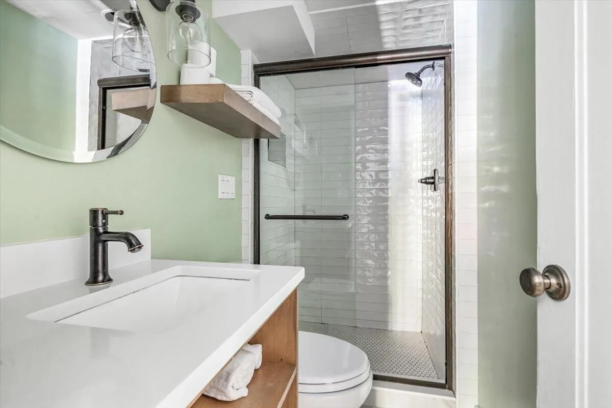 Modern Bathroom with Green Walls & Tiled Shower