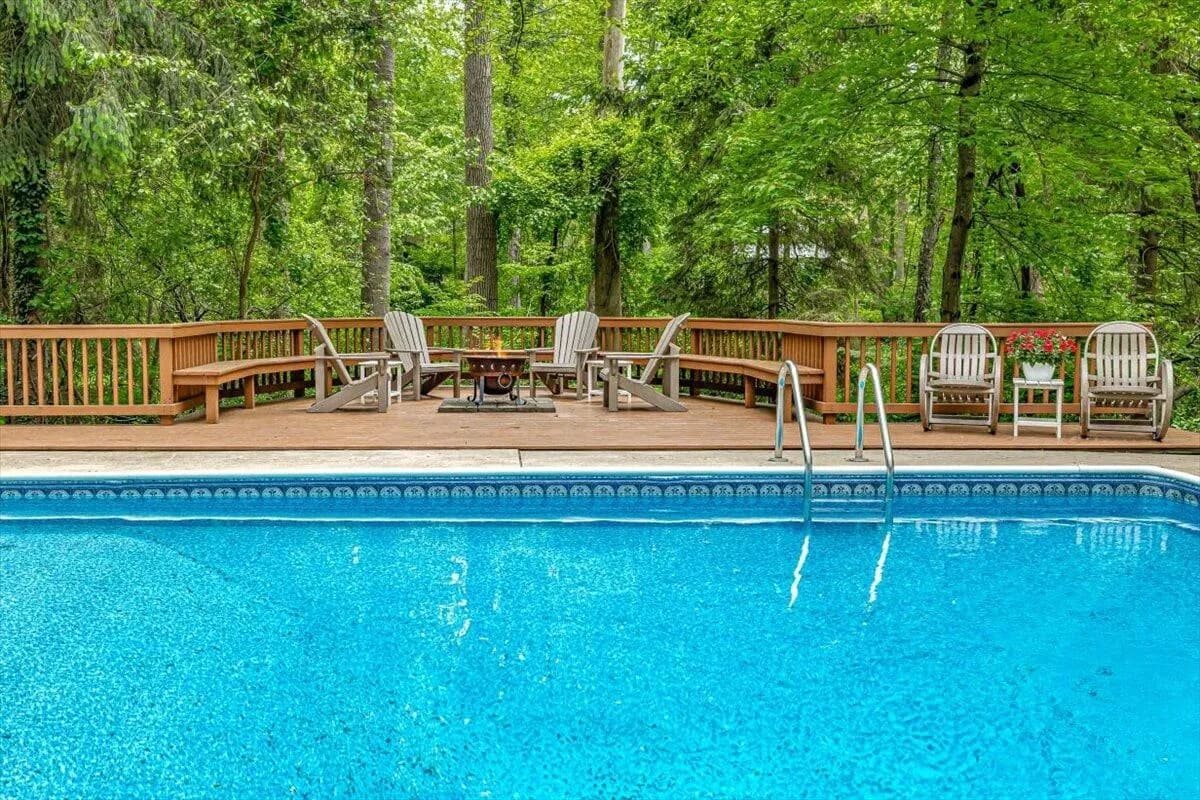 Pool Deck with Outdoor Furniture & Forest Setting