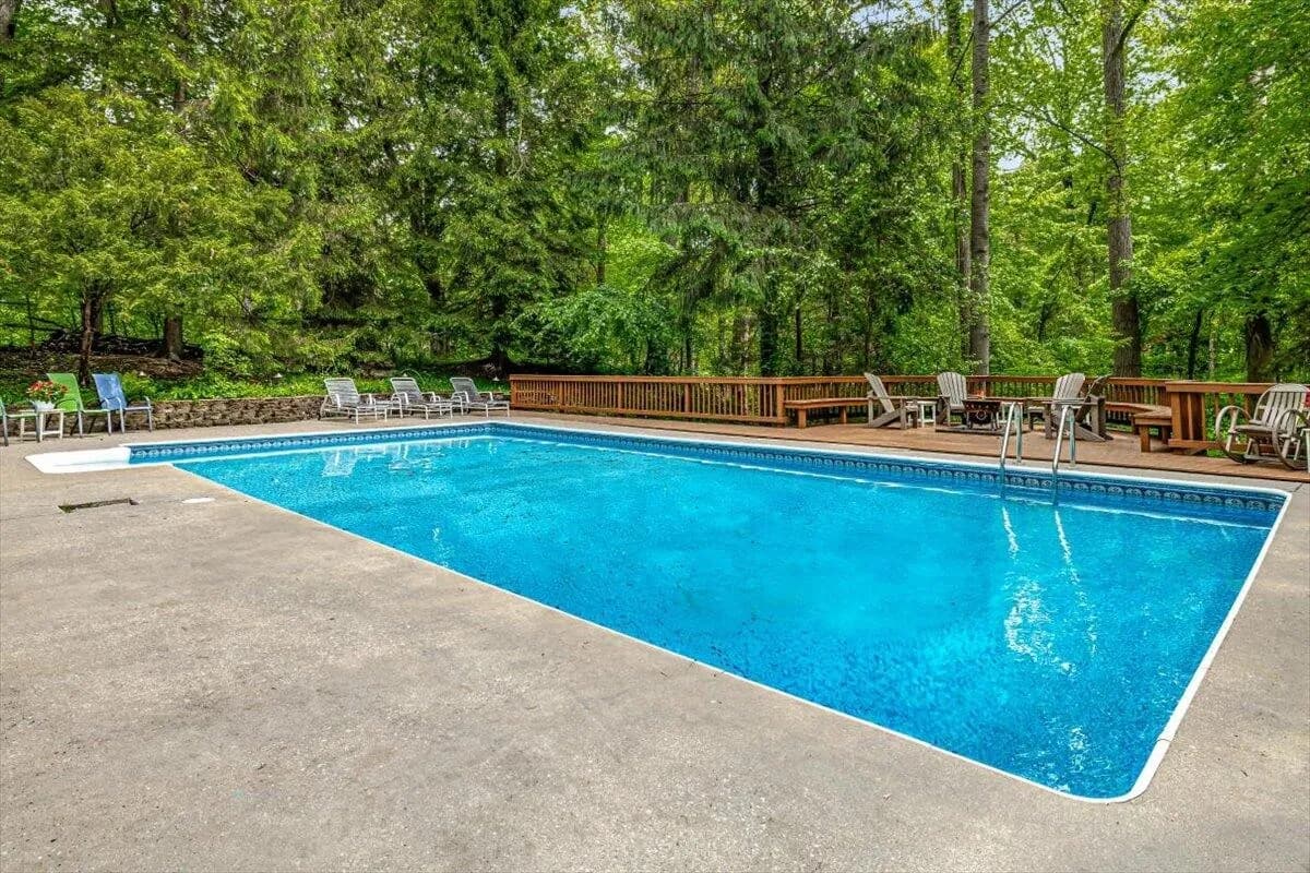 Swimming Pool with Deck Furniture & Forest Views